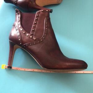 Vince Camuto heels boots.Burgundy leather. Dark metal studs.Almost new condition